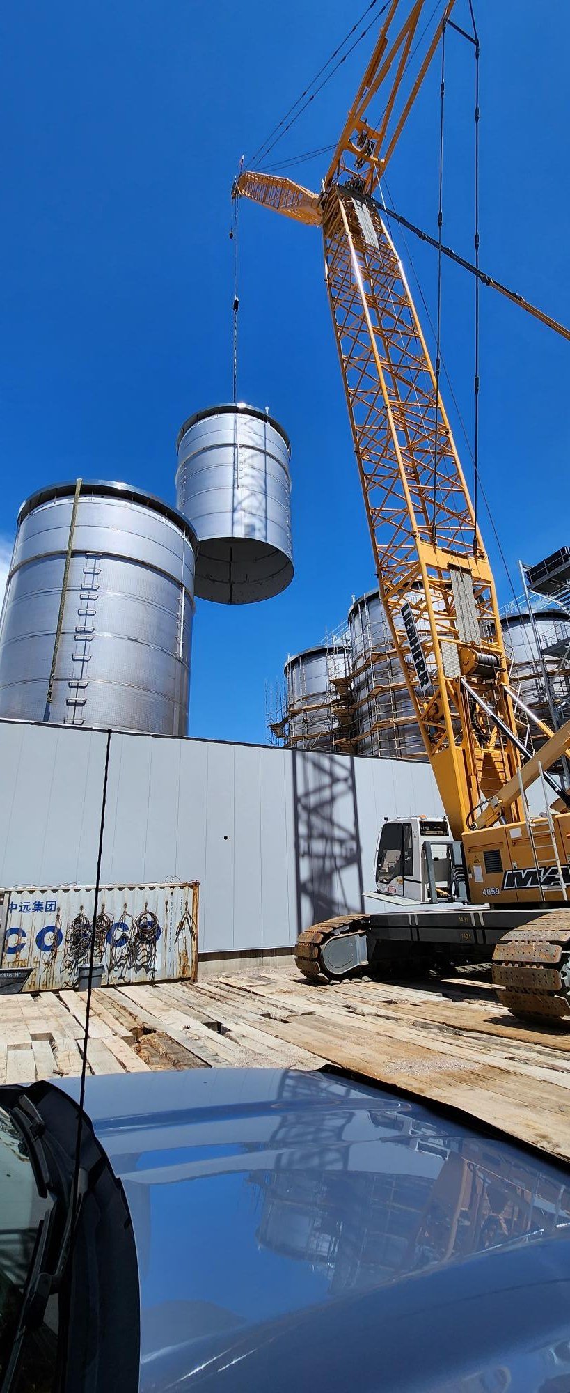 Crane setting a stainless fermenter